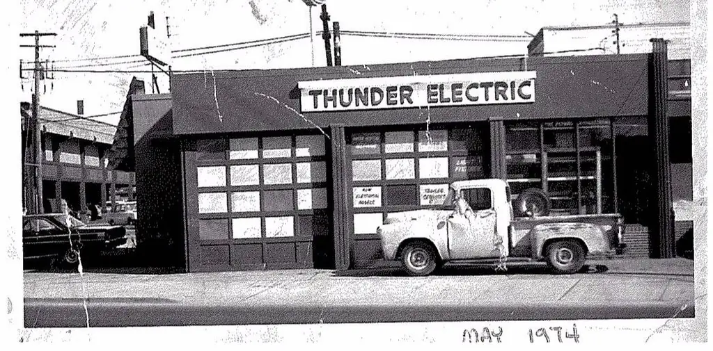 Black-and-white photo of the original Thunder Electric storefront with a pickup parked out front, captioned May 1974